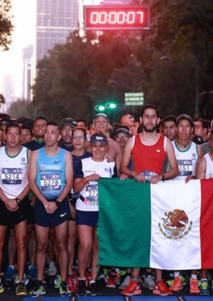 Federal Police Race 2018 — runners holding Mexican flag